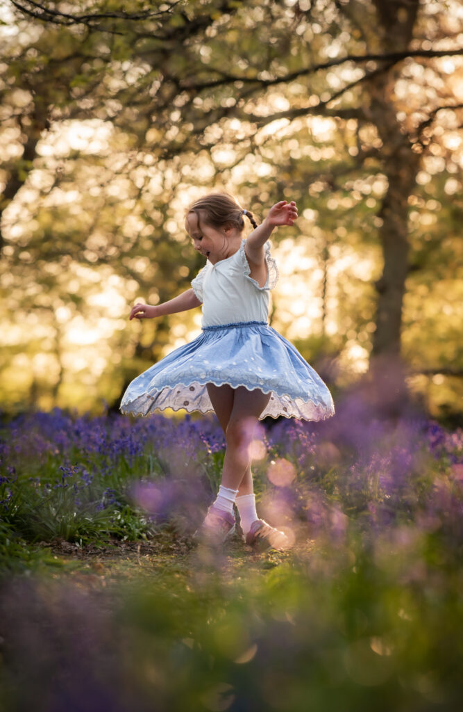 Girl dancing in the bluebell woods